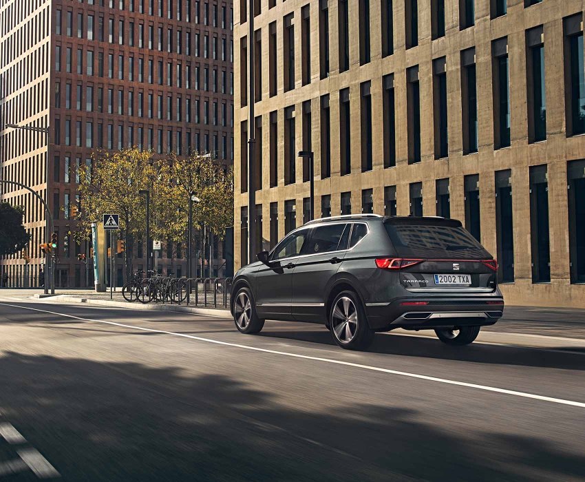 SEAT Tarraco - Rear view of the car driving in the city
